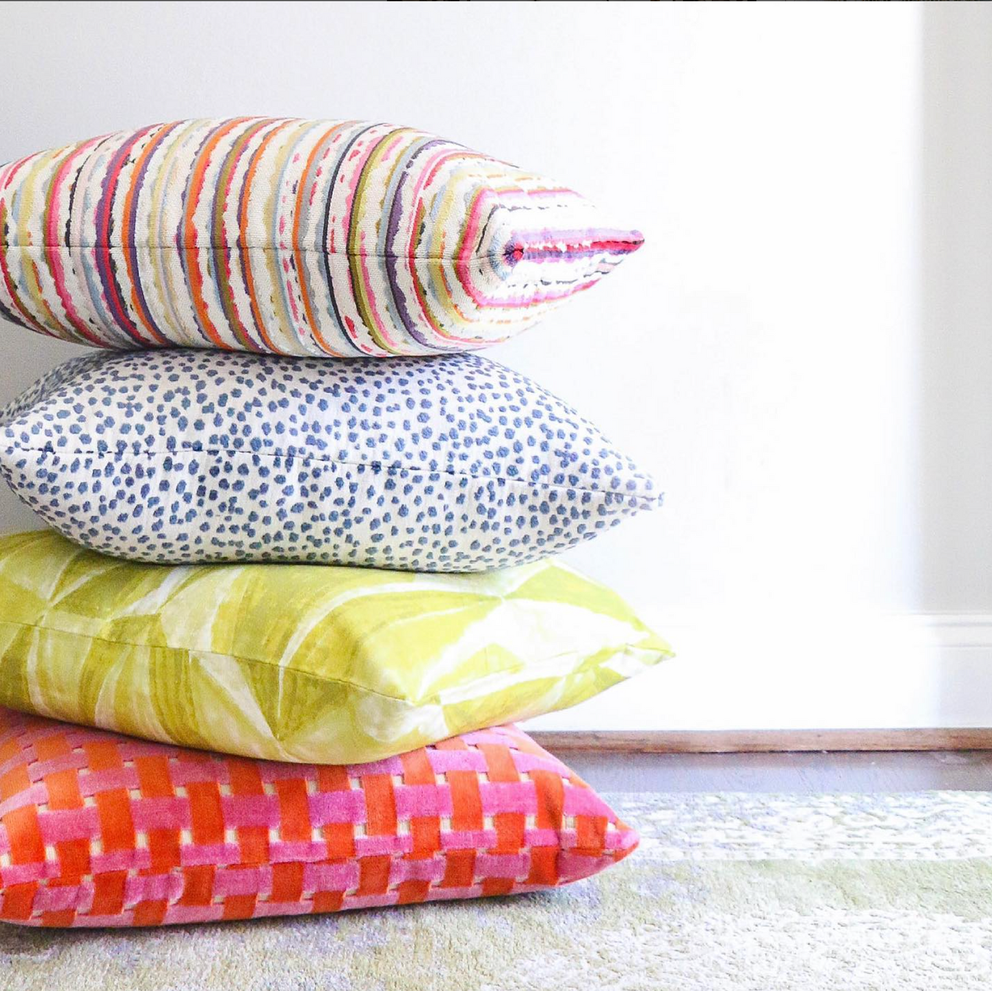 A stack of vivid colored high end pillows 